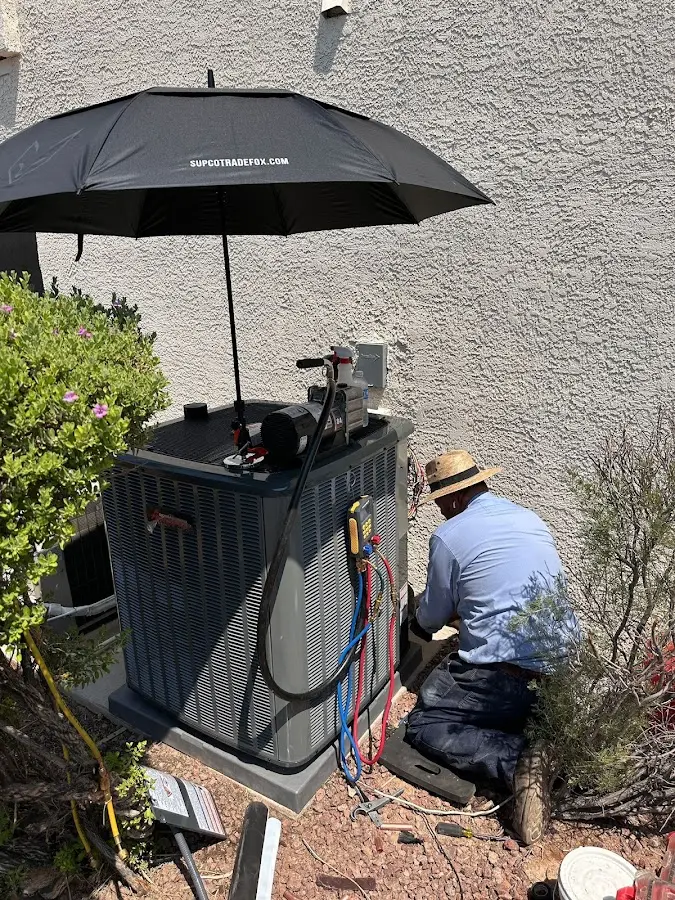 HVAC technician performing outdoor AC maintenance in Loma Linda